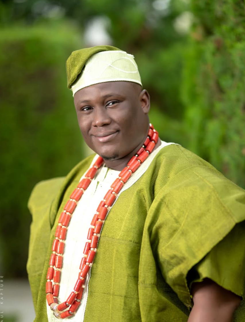 Portrait of a man in a green agbada and cap outdoors