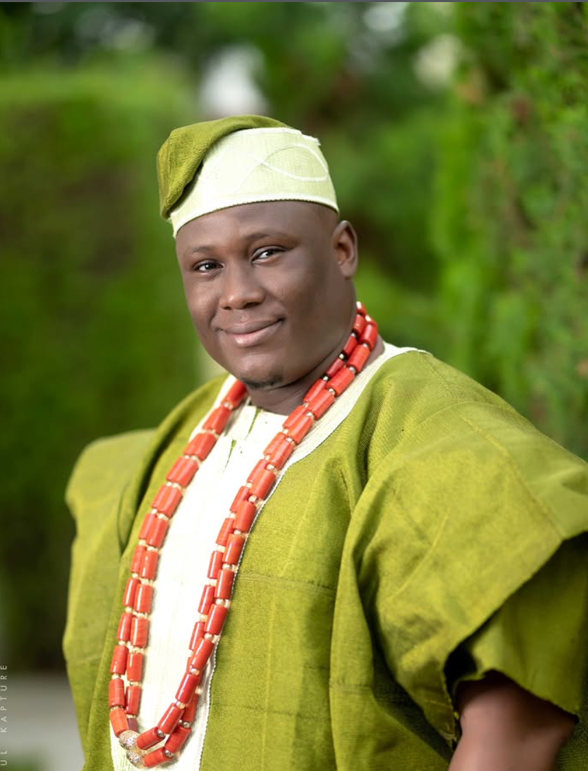 Man in a green agbada with coral beads